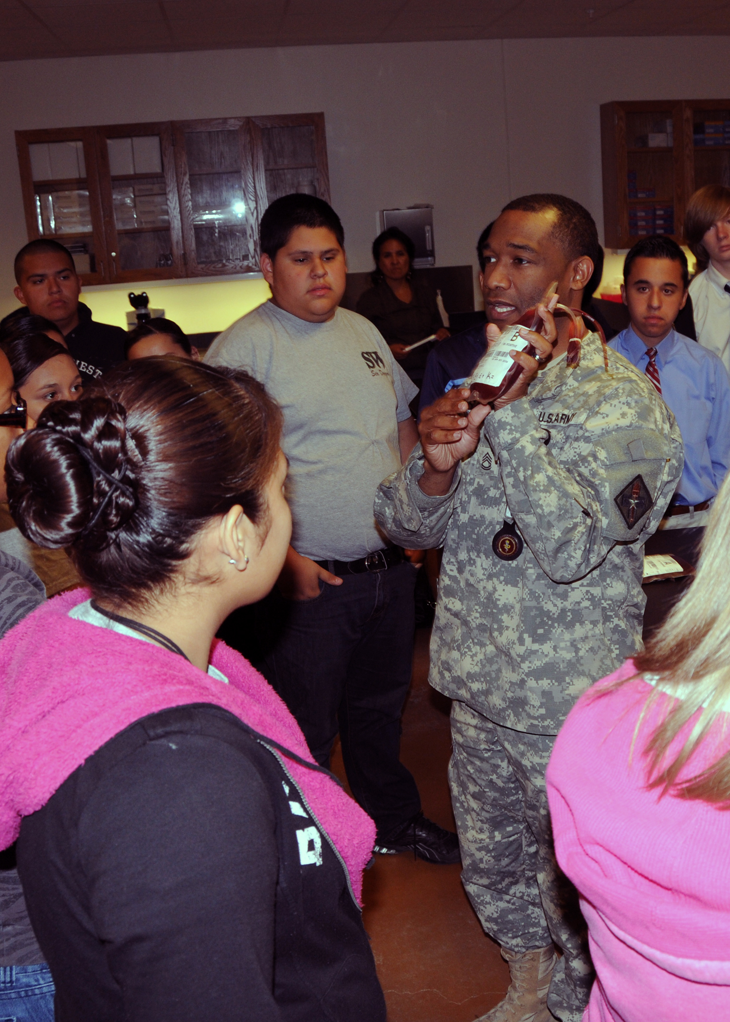 An instructor at the Medical Education and Training Campus aboard Fort Sam Houston gives a lesson about blood-typing to high school students from area schools who attended the Association of Naval Service Officers “Youth Day,” May 4, 2011, in San Antonio.